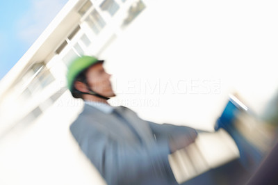 Blurred motion of a business man riding a scooter