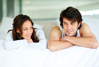 Cute love couple lying on bed and looking at each other