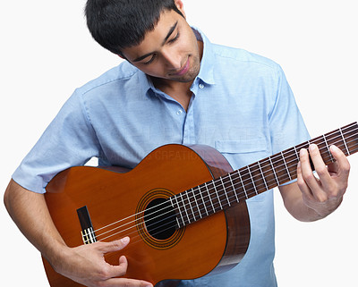 Young musician playing a guitar isolated against white