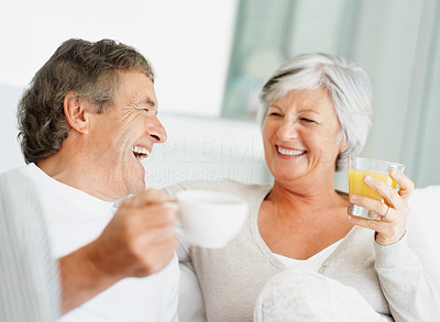 Relaxed old couple enjoying beverages together