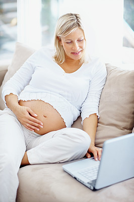 Pregnant woman searching information about childcare on internet