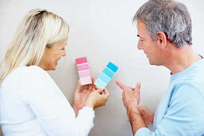 Woman seeking help from a man on which color to paint the wall