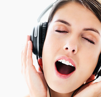 Closeup of an excited young girl listening to music eyes closed
