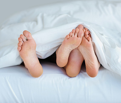 Couple in bed , focus on their feet