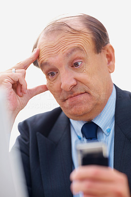 Closeup of a displeased business man holding a cell phone