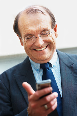 Good News - Senior business man reading a text message