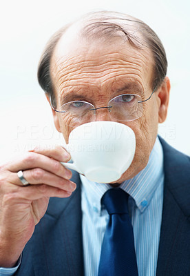 Closeup of a senior business man drinking tea