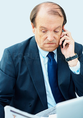 Senior business man talking on the phone at work