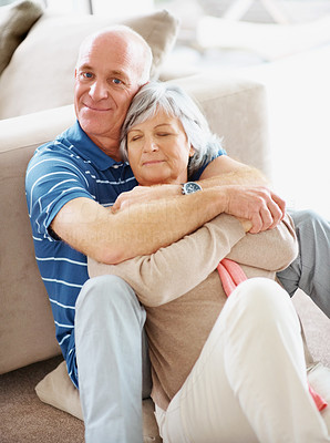 Romantic happy senior man embracing his pretty wife at home