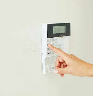 Closeup of a person entering a pin into the home alarm