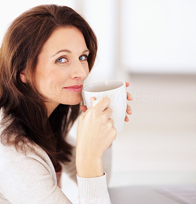 Portrait of a happy woman drinking coffee