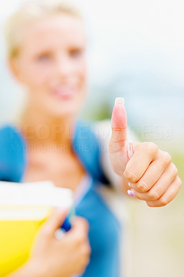 Female student showing a thumbs up sign