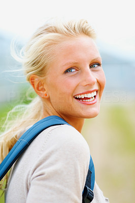Portrait of a female college student laughing outdoors