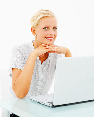 Charming young female using a laptop on white