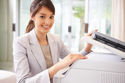 Happy business woman working on the photo copy machine