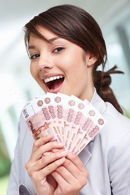 Cute female smiling with fan of currency notes