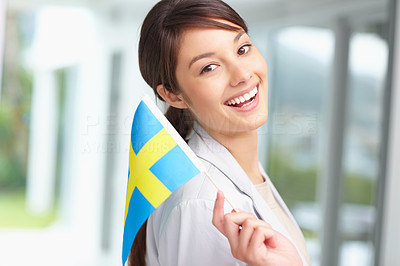 Portrait of a young female holding a swedish flag