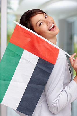 Happy young woman with a United Arab Emirates flag