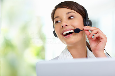 Young female employee talking on headset