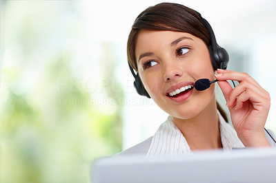 Young female employee speaking on headset