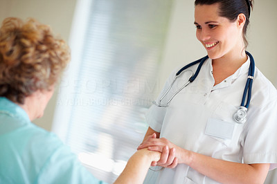 Female nurse having a casual talk with a woman