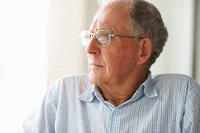 Sad old man looking away in thought