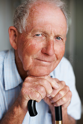 Portrait of a happy elderly man with a walking stick