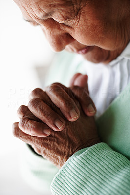 Cut image of a senior woman praying