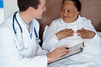 Routine checkup - Doctor making a report of an elderly patient