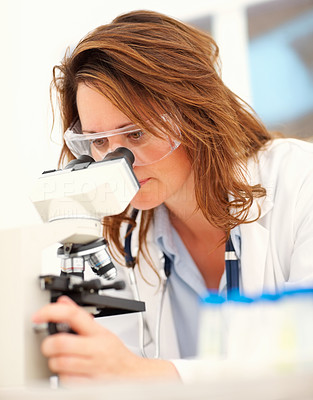 Woman scientist working with a microscope