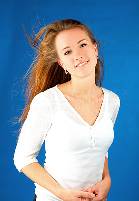 Smiling casual girl on blue background