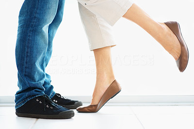 Low section of a couple standing together , focus on legs