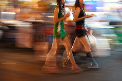Two Thai women walking with their take-aways
