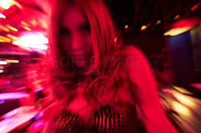 Blonde transgender woman in nightclub with motion blur effect