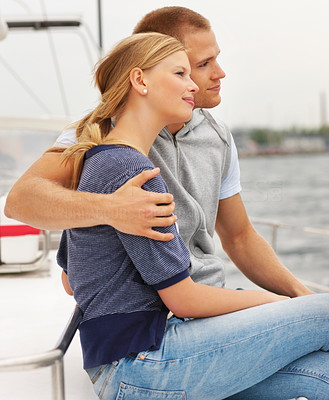 Happy young couple enjoying a sea voyage on a sailboat