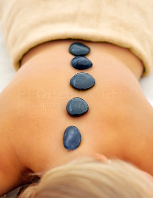Hot stone therapy: Stones placed on a female's back