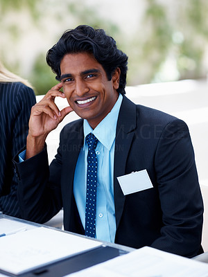 Happy Asian man smiling during a business meeting