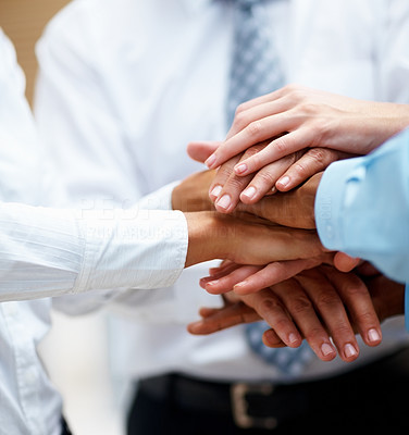 Hands of businesspeople on top of each other as symbol of their partnership