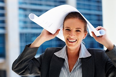 Successful business woman holding a sheet of paper over head