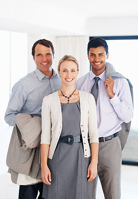 Three successful executives smiling at work