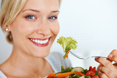 Pretty woman eating salad