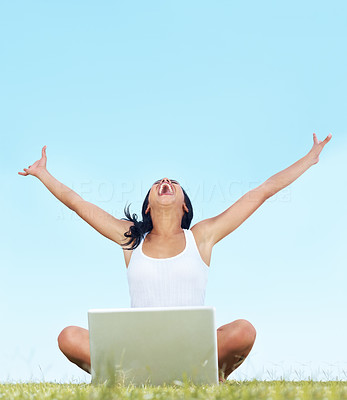 Excited young woman with a laptop enjoying success