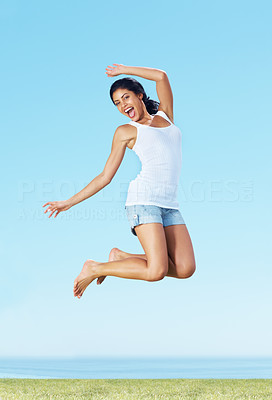 Excited young woman jumping in air - Outdoor