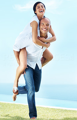 Cheerful man giving woman piggyback ride on one leg