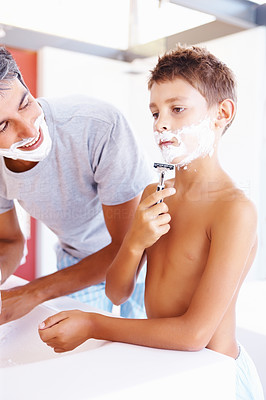 Father grooming his son for the procedure of shaving
