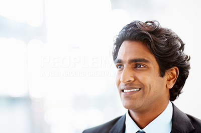 Indian business man looking away in a contemplative mood