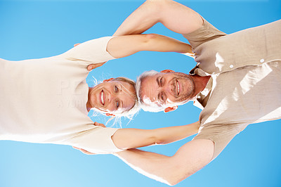 Upward view: Senior old couple with their heads together