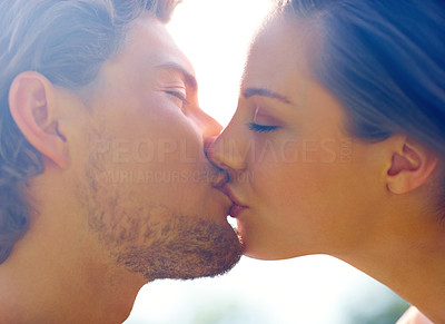 Portrait of a romantic young couple kissing with eyes closed