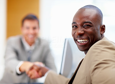 African American business man shaking hands with a colleague at a meeting