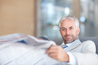 An aged business man reading newspaper